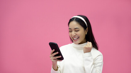 Asian woman smiling and using mobile phone with tablet and excited for online shopping on isolated...