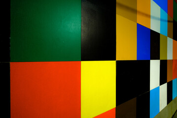 Wide angle photograph of a colourfully tiled exterior wall