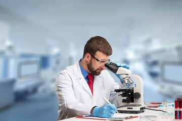 science research, work and people concept, scientist with microscope working in laboratory