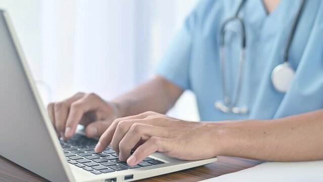 Doctor working with computer notebook in hospital office, Healthy medical concept