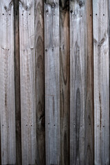 A weathered timber fence, lapped paling fence