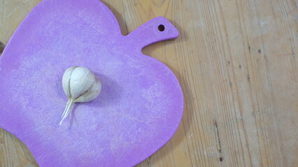 garlic on purple chopping board