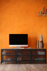 Orange living room interior with black metal Tv stand and monitor. Modern room design, vertical orientation