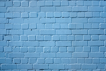 Close up of an old brick wall painted blue, featuring a nice surface texture.