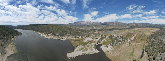 Flying over lake with mountains behind 