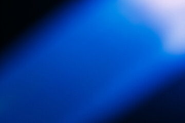Blur light rays. Defocused neon glow. Sci-Fi illumination. Bokeh navy blue color gradient ultraviolet radiance flare on dark black futuristic abstract copy space background.