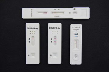 Multiple Covid-19 antigen test kits isolated on black background. Coronavirus protective concept