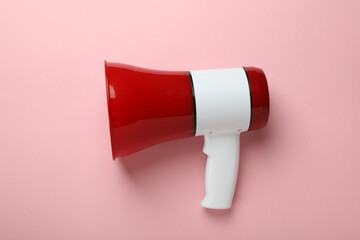 Red and white megaphone on pink background