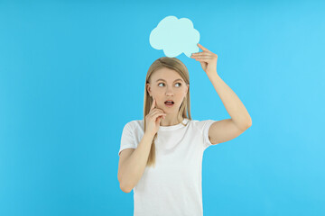 Young woman with speech bubble on blue background