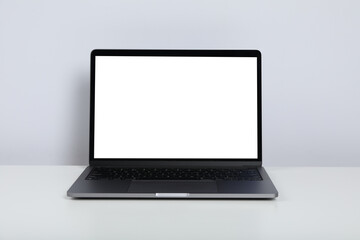 Laptop with blank screen on white table