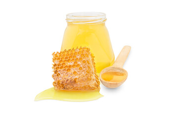 Isolate jar with honey next to a piece of wax and a spoon filled with honey