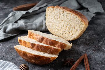 Freshly baked homemade bread with crispy crust on gray stone background