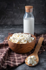 Traditional homemade cottage cheese in a wooden bowl Healthy and fermented food