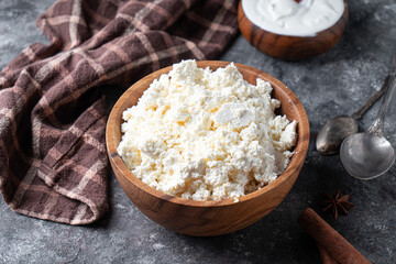 Traditional homemade cottage cheese in a wooden bowl Healthy and fermented food