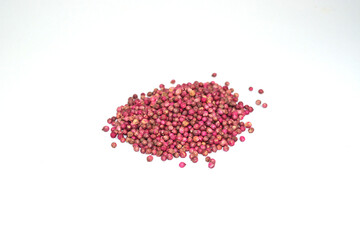 coriander seed pile Red dye for long-lasting maintenance on a white background.