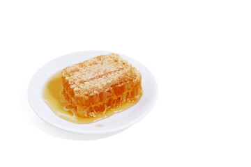 beeswax honeycomb yellow natural honey slices on white plate isolated on white background