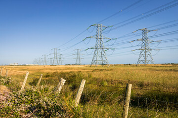 Lines of power pylons from Dungeness power station on Romney Marsh Kent south east England