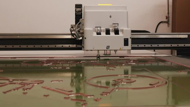 Industrial flexo prepress cutter working on large flexible relief plate sheet - wide shot