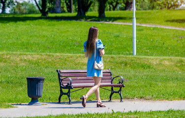 Girl walks in the city summer Park
