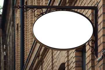 Mock up. Empty white signage of shop, store, restaurant, office on classic brick building wall in...
