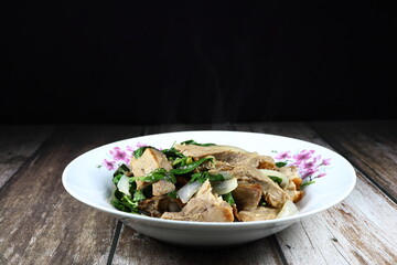 Traditional spicy duck meat mixed with basil and onion serving on the plate. Famous menu in Chinese restaurant.