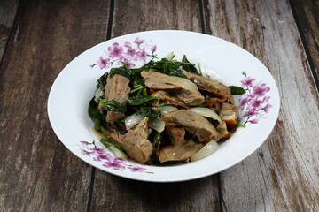 Traditional spicy duck meat mixed with basil and onion serving on the plate. Famous menu in Chinese restaurant.