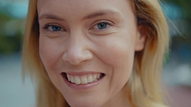 close up video portrait of a young beautiful woman smiling and doing face expressions in camera