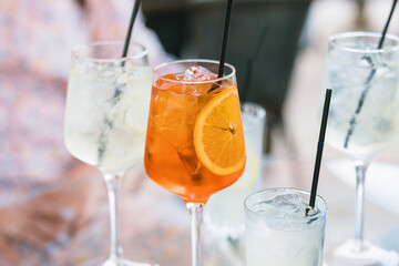 Refreshing summer cocktails on dinner table on terrace. Summertime. 