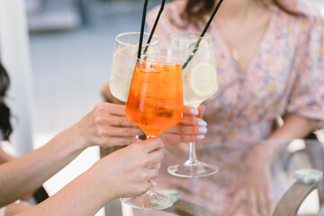 Fototapeta premium Friends having lemonade drinks on outdoors terrace. Summer lifestyle.