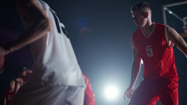 International basketball training game, the confrontation between two teams, sporty lifestyle, mens active game at night time, cinematic light.
