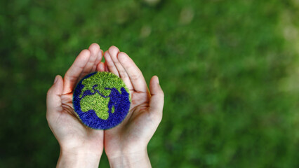 Hands holding the earth on a green background to protect nature Save and care World for sustainable. concept of the environment ecology and Earth Day