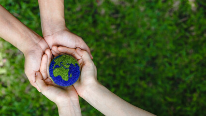 Many hands person holding the earth on a green background to protect nature Save and care World for...