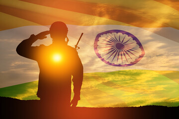 Silhouette of soldier saluting on a background of India flag and the sunset or the sunrise. Greeting card for Independence day, Republic Day. India celebration.