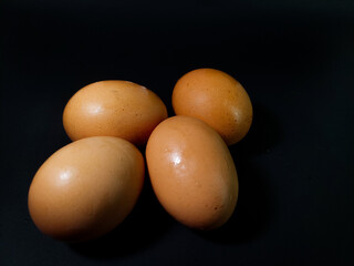 chicken eggs on a black background.