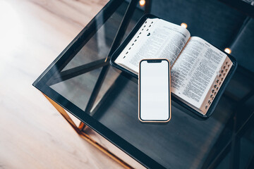 Phone screen blank and Bible on the table
