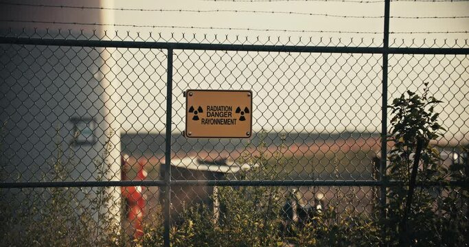Nuclear Radiation Danger Sign on Barbed Wire Perimeter Fence in Exclusion Zone Slow Motion 4K