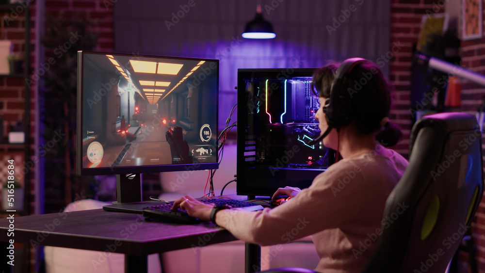 Poster gamer girl using pc setup playing multiplayer first person shooter talking on headset while explaini