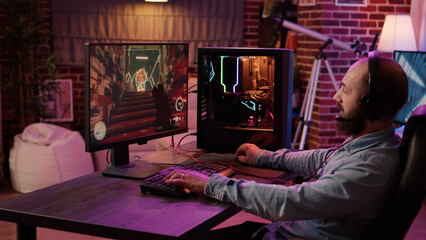 Caucasian man enjoying video game playing action first person shooter tournament using professional pc gaming setup and headset. Male gamer streaming gameplay in online competition from living room. © DC Studio