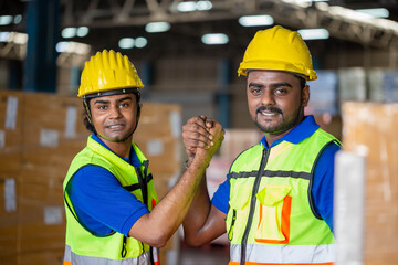 Workers man soul brother handshake, thumb clasp handshake or homie handshake with blurred warehouse background, Success and Teamwork concepts
