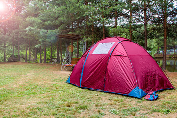 red camping tent at the campsite. the concept of outdoor recreation.