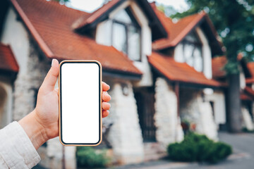 Phone with isolated screen on the background of the cottage