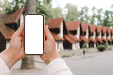 Phone with isolated screen on the background of the cottage