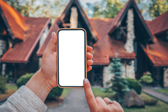Phone with isolated screen on the background of the cottage