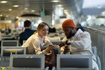 Attractive European woman asks African American hipster man to help connect wifi. New acquaintances...