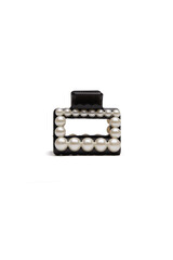 Subject shot of a black hair clip decorated with pearls. The hair clip is isolated on the white background. Vogue accessory for ladies and girls.