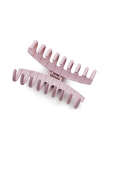 Subject shot of a pink hair clip. The open hair clip is isolated on the white background. Vogue accessory for ladies and girls.