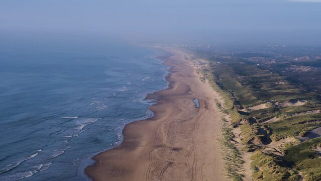 A dynamic aerial footage of the dunes of Meijendel which is the largest contiguous dune area in South Holland. You can also see the city of Den Haag from afar in the background covered by the fog.