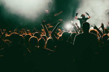 Crowd at concert and blurred stage lights.