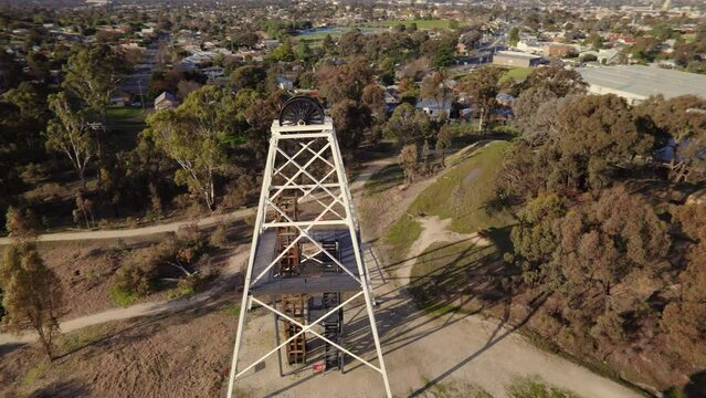 Circling drone shot of Victoria Hill Mining Reserve poppet head in Bendigo