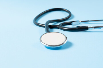 Fototapeta premium Close up view of stethoscope on the blue background.